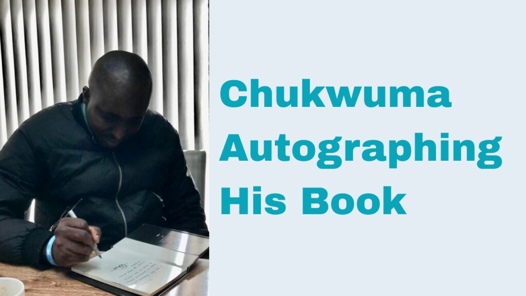chukwuma autographing his book